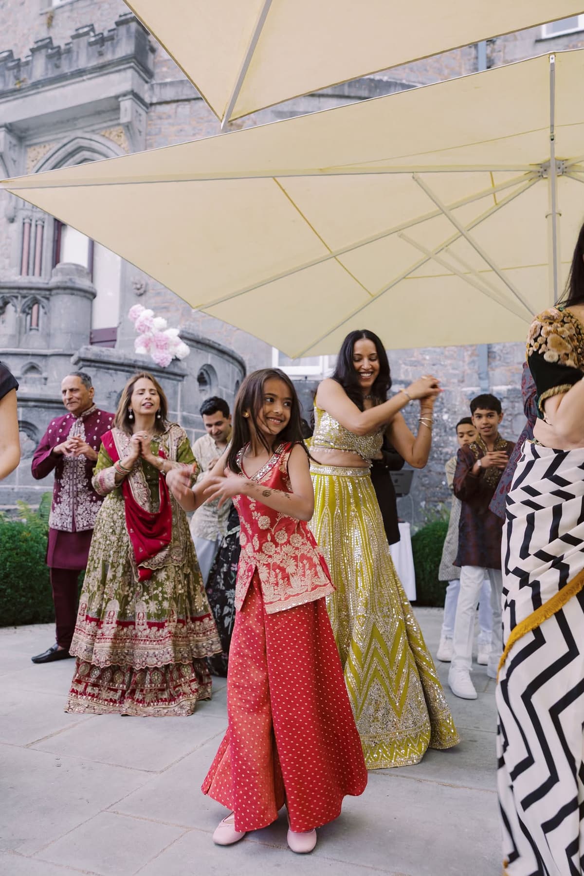 Family and guests dancing at a colourful Indian wedding celebration in Ireland