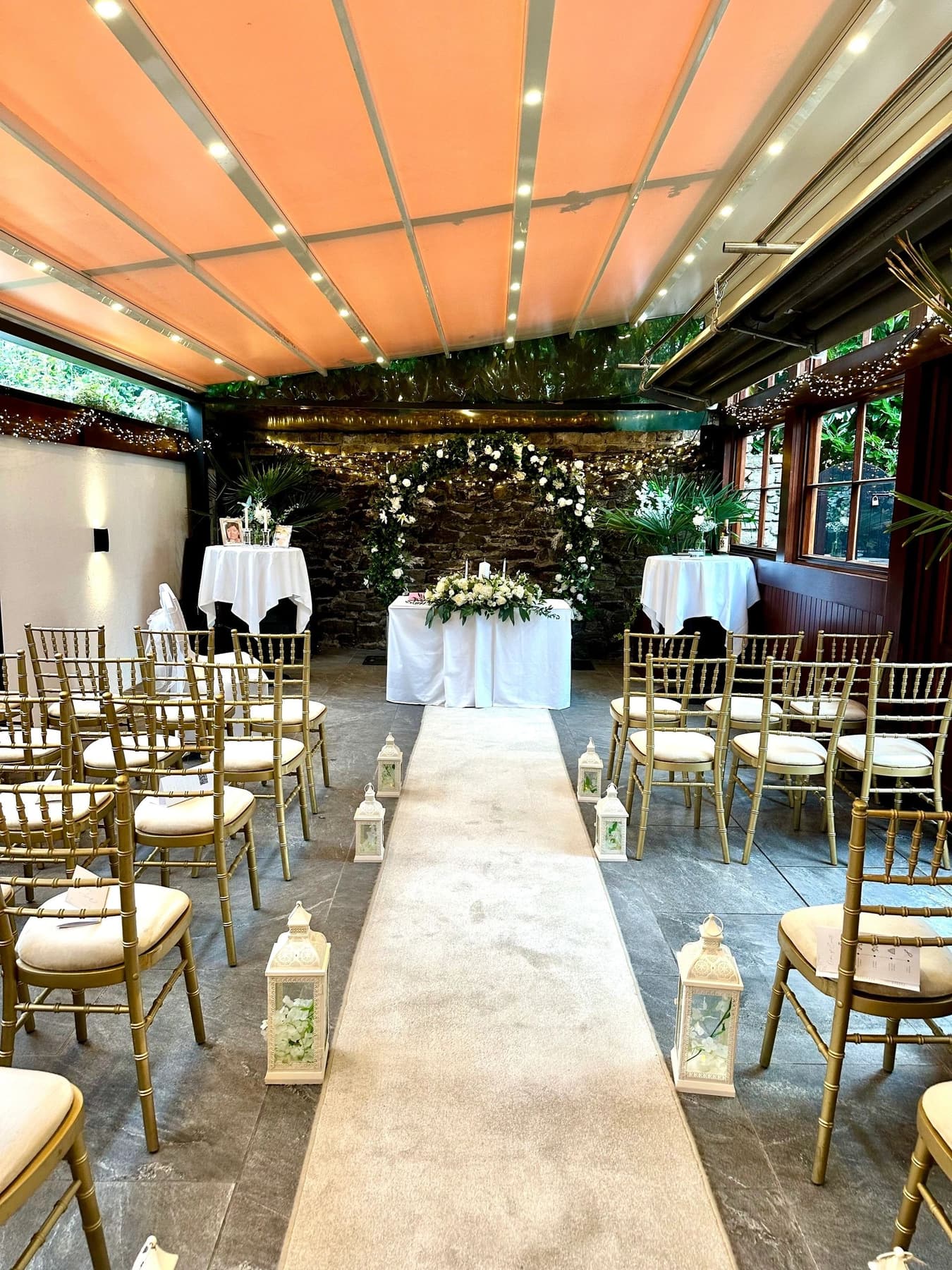 Wedding aisle styling with white chair drapes and floral detail